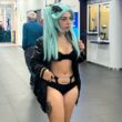 A model says she was banned from boarding her flight for wearing a revealing cosplay outfit sparking debate as fans defend her and others say airport staff were right to enforce rules.