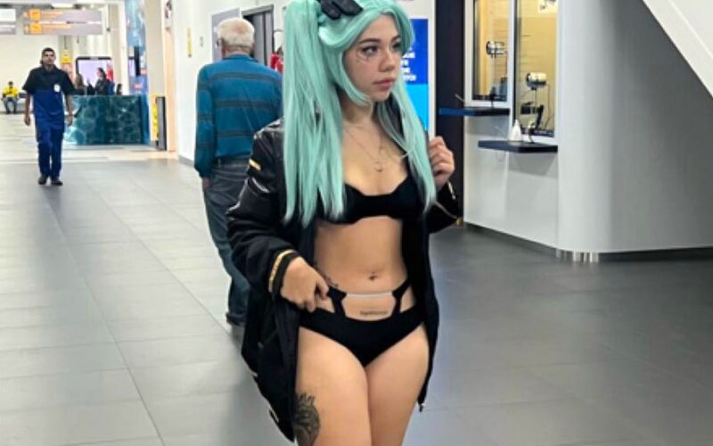 A model says she was banned from boarding her flight for wearing a revealing cosplay outfit sparking debate as fans defend her and others say airport staff were right to enforce rules.