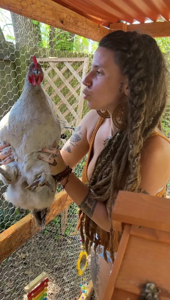 Indica Flower with one of the chickens she keeps at home - NudeNewz