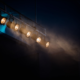 Row of stage spotlights hanging from a ceiling, representing mainstream celebrities crossing into the creator economy