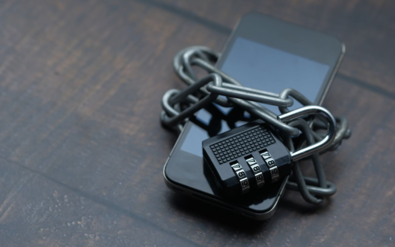 Smartphone secured with a padlock and chain, representing digital privacy and protection from deepfakes