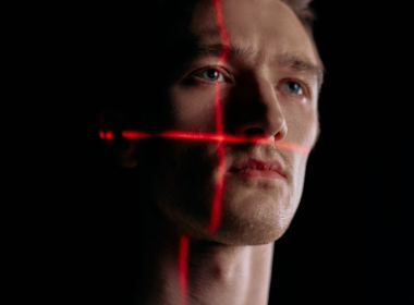 Facial-scan grid overlay on a portrait, representing AI and deepfake content detection policy