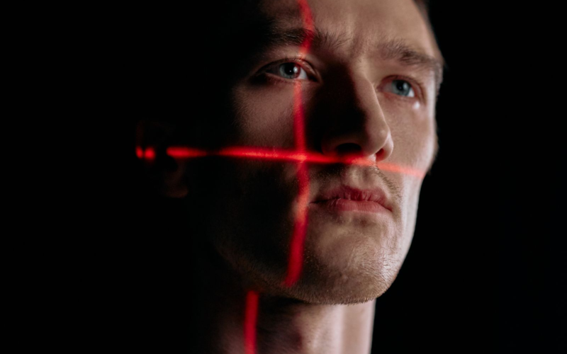 Facial-scan grid overlay on a portrait, representing AI and deepfake content detection policy
