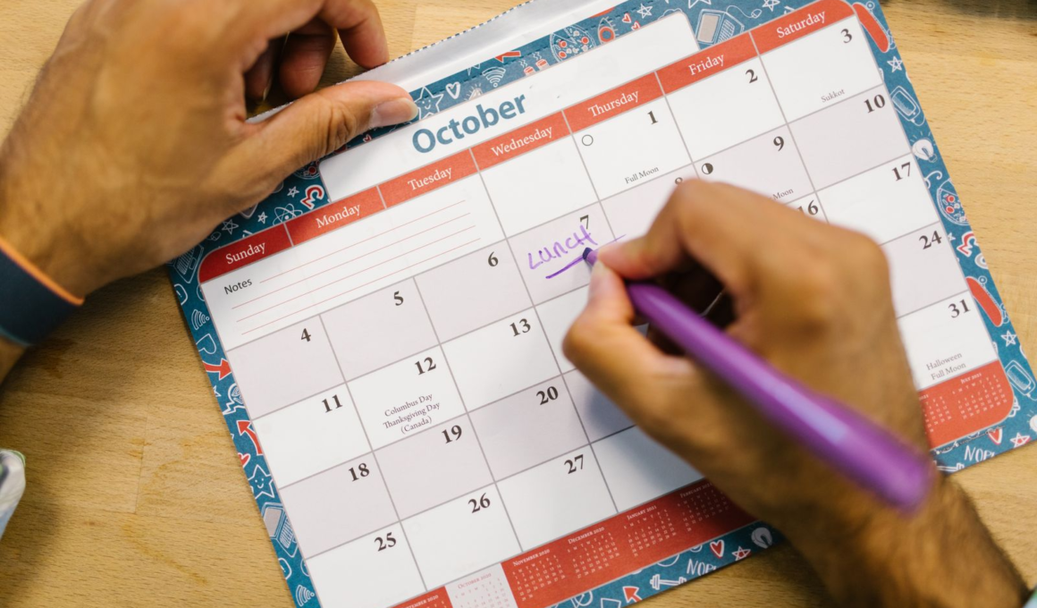 Hands writing on a paper calendar, representing content planning for creators