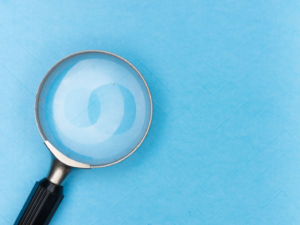 Magnifying glass on a plain background, representing the search for discoverability on creator platforms