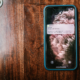 Smartphone on a wooden surface showing a message notification, representing fan engagement and retention for creators
