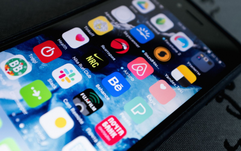 Smartphone screen full of app icons, representing a comparison between creator subscription platforms