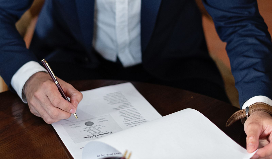 Person signing a legal document, representing UK Online Safety Act age-verification compliance